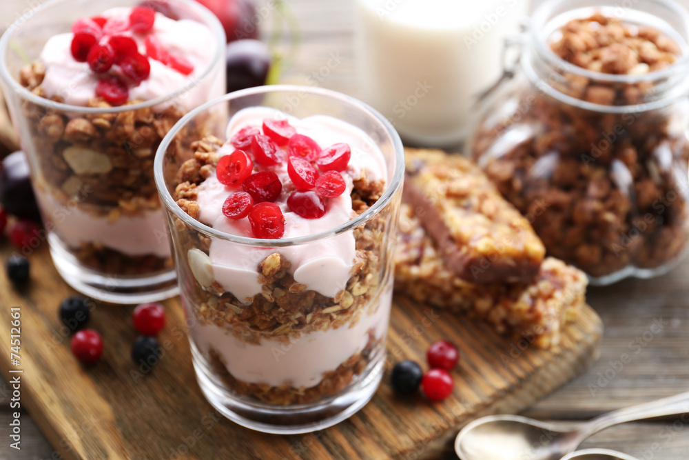 Healthy layered dessert with muesli and berries on table Healthy layered dessert with muesli and berries on table