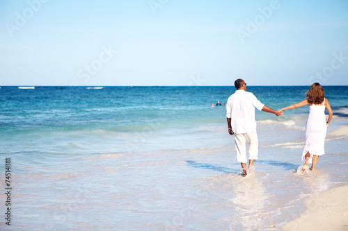 Romantic couple walking on beach