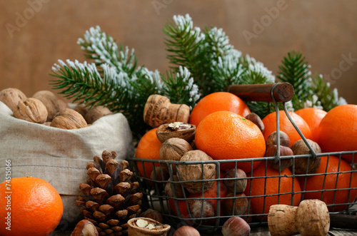 Xmas decoration with tangerines and nuts with copyspace on woode