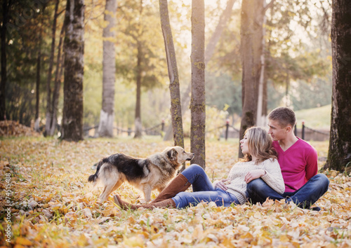 young couple with dog in autumn park © Maya Kruchancova