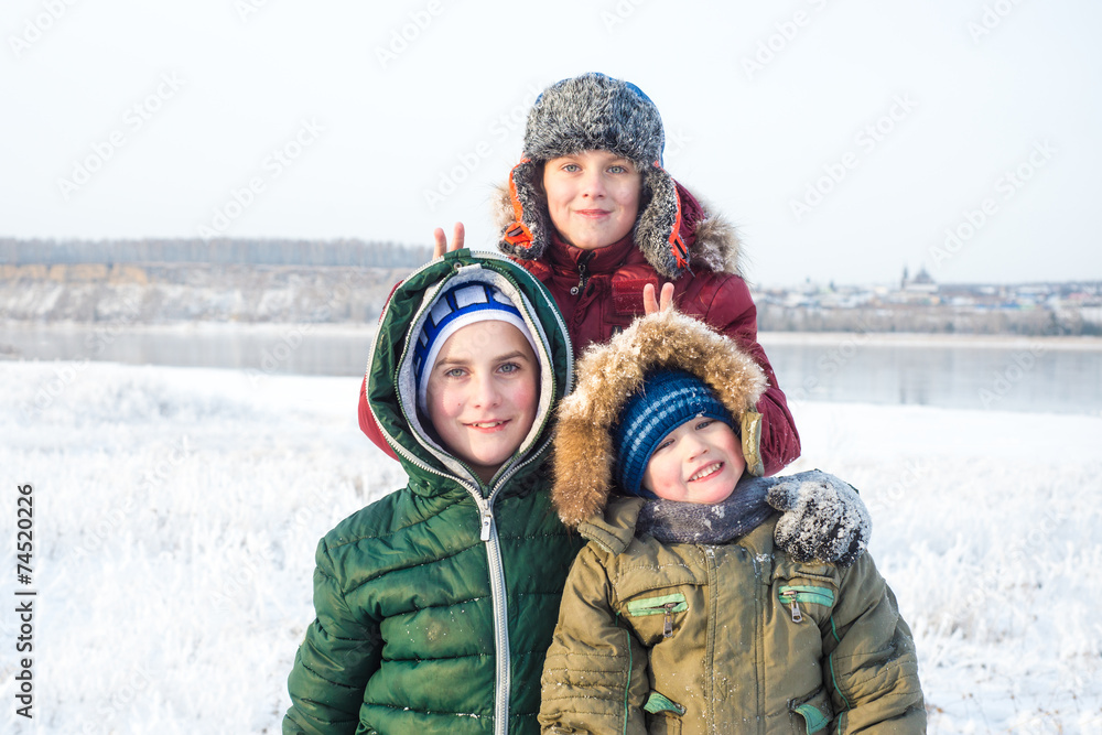Group of children playing on snow in winter time