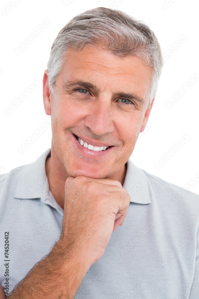 Casual man smiling with hand on chin Casual man smiling with hand on chin
