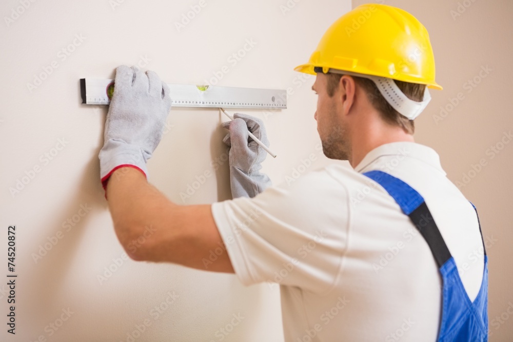 Construction worker using spirit level Construction worker using spirit level