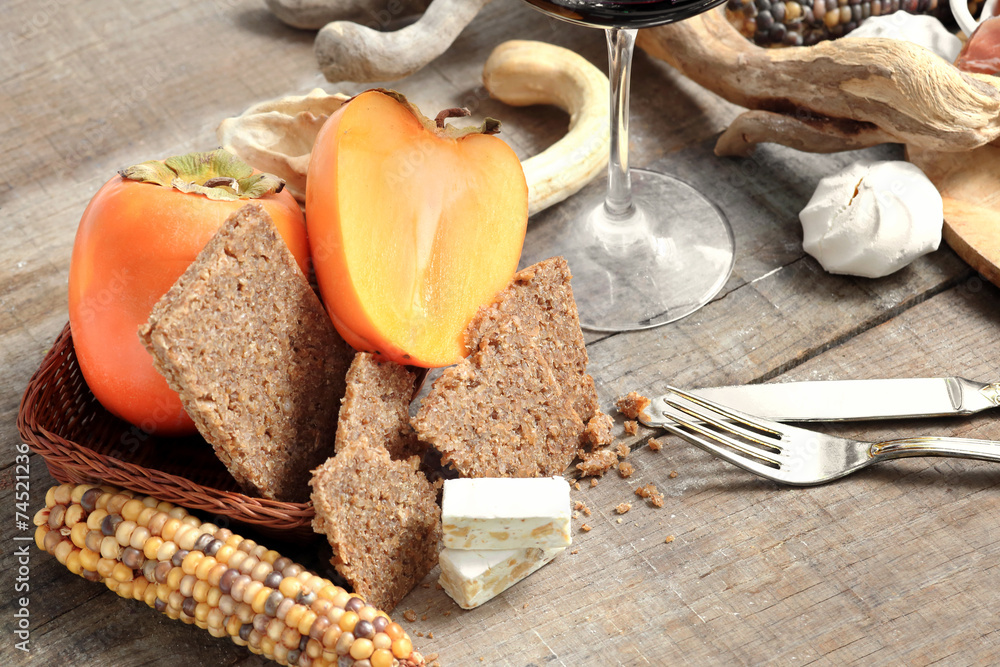 winter gourmet composition with persimmon, cereal  bread and nou