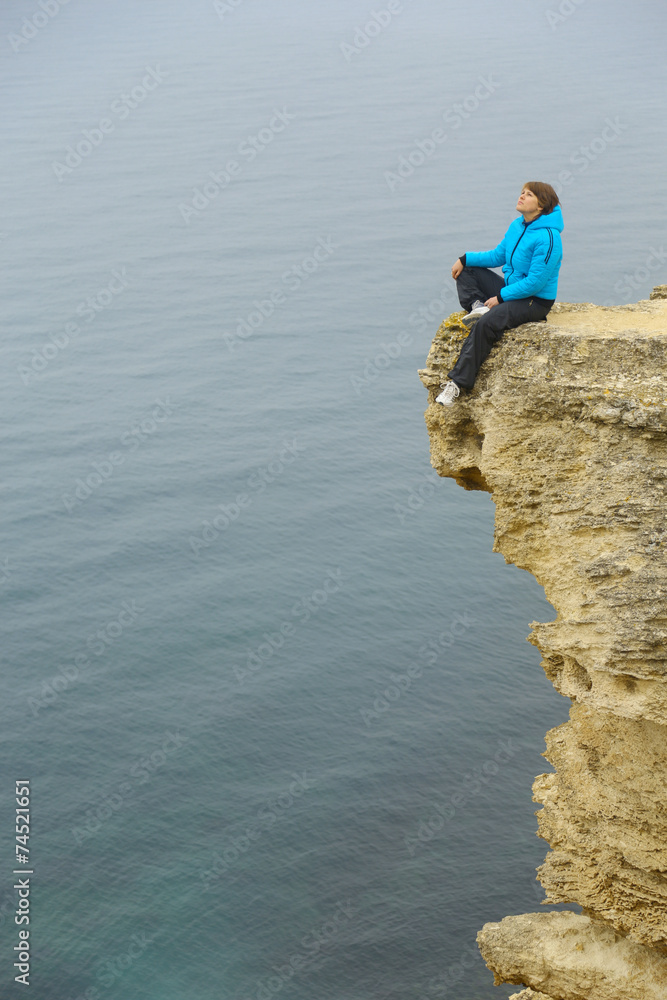 beautiful woman on a cliff above the sea beautiful woman on a cliff above the sea