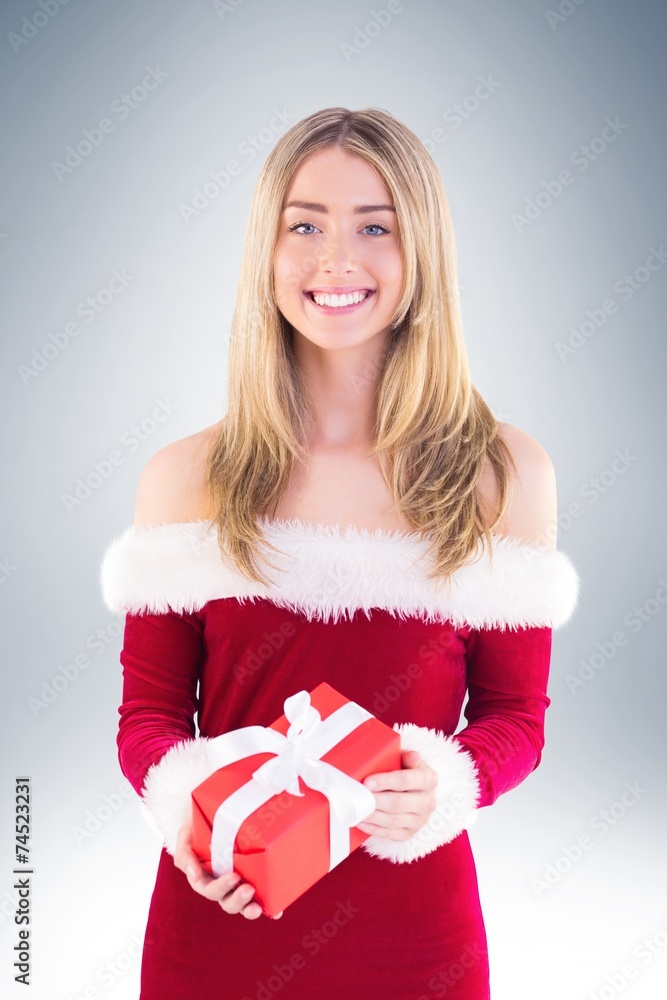 Fototapeta premium Pretty santa girl holding gift