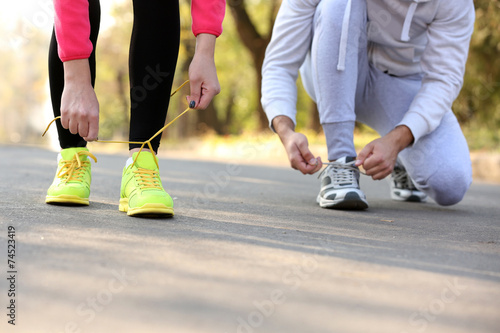 Runner feet on road, outdoors