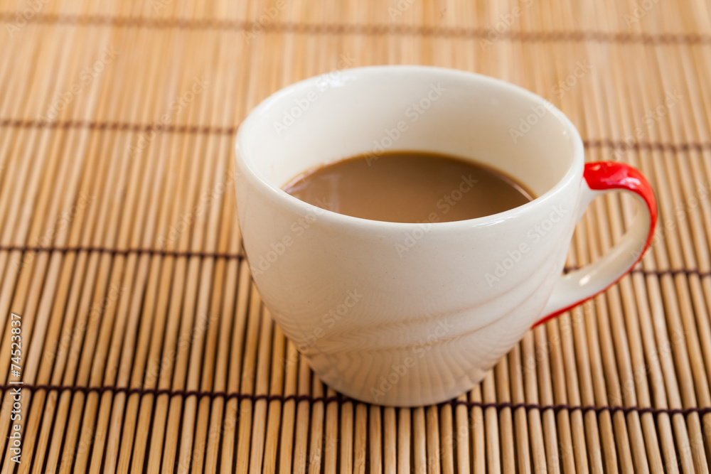 Obraz premium Cup of hot coffee on wooden table.