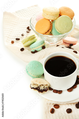 Gentle colorful macaroons in glass bowl and black coffee in mug