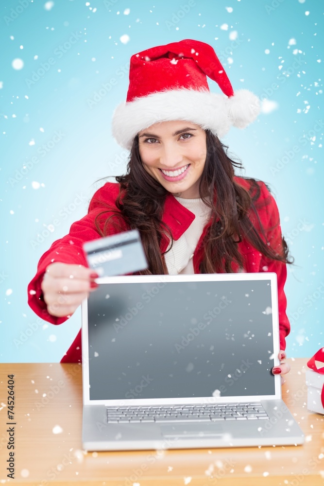 Composite image of festive brunette shopping online Composite image of festive brunette shopping online