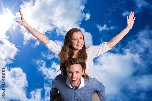 Composite image of smiling young man carrying woman