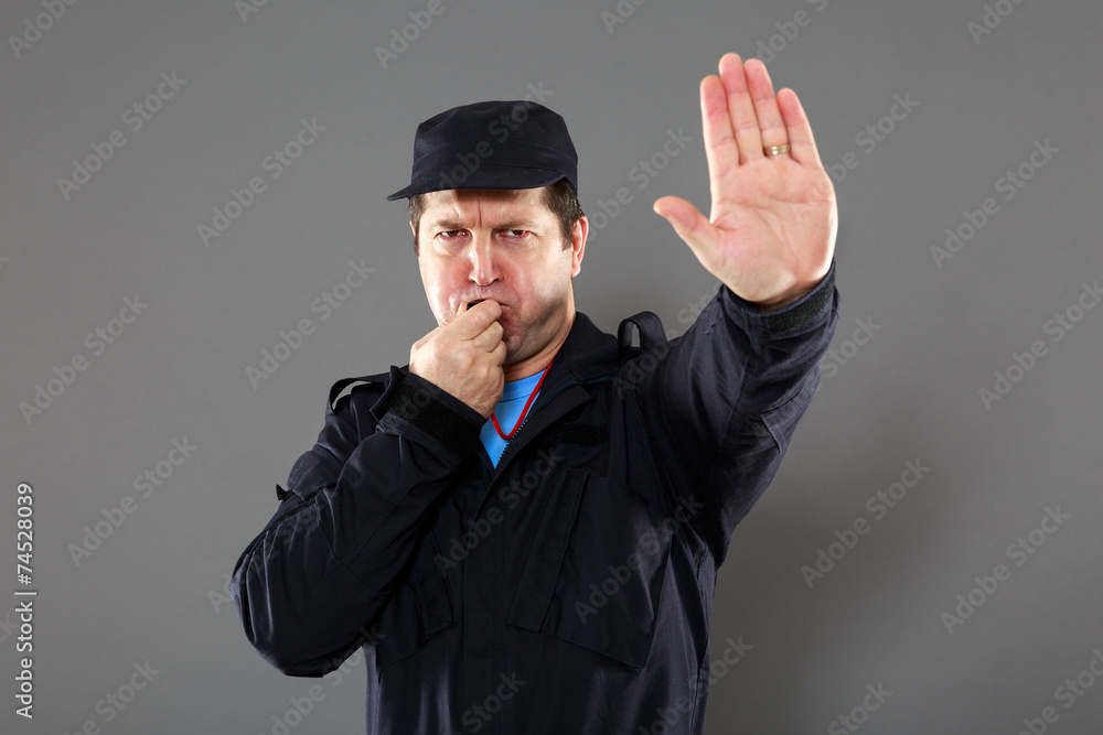 security officer making the stop sign. grey background security officer making the stop sign. grey background