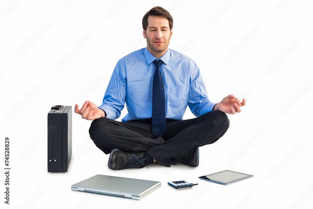 Man sitting in lotus pose with laptop, tablet and suitcase Man sitting in lotus pose with laptop, tablet and suitcase