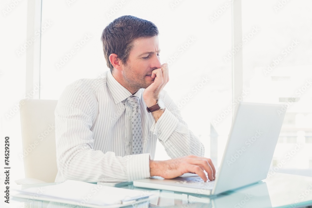 A businessman working at desk A businessman working at desk