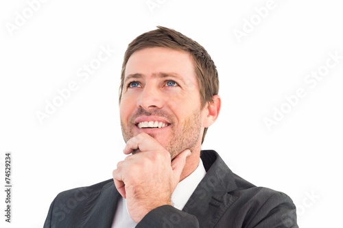 Businessman smiling and thinking