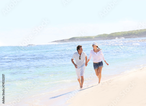 Couple running on a Caribbean beach