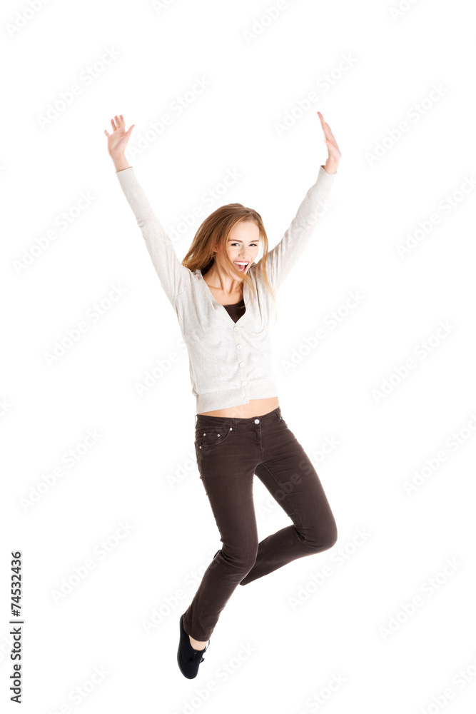 Full length young woman jumping Full length young woman jumping
