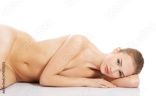 Sexy fit naked woman lying down