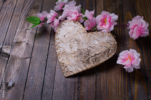 Heart on wooden background.