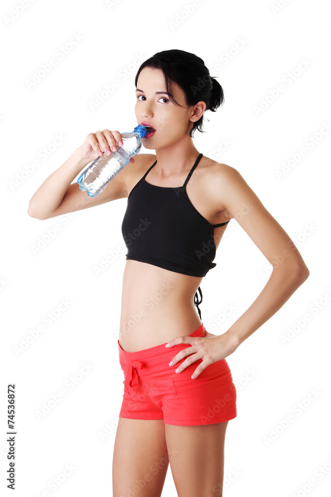 Athletic woman drinking water in sportswear Athletic woman drinking water in sportswear