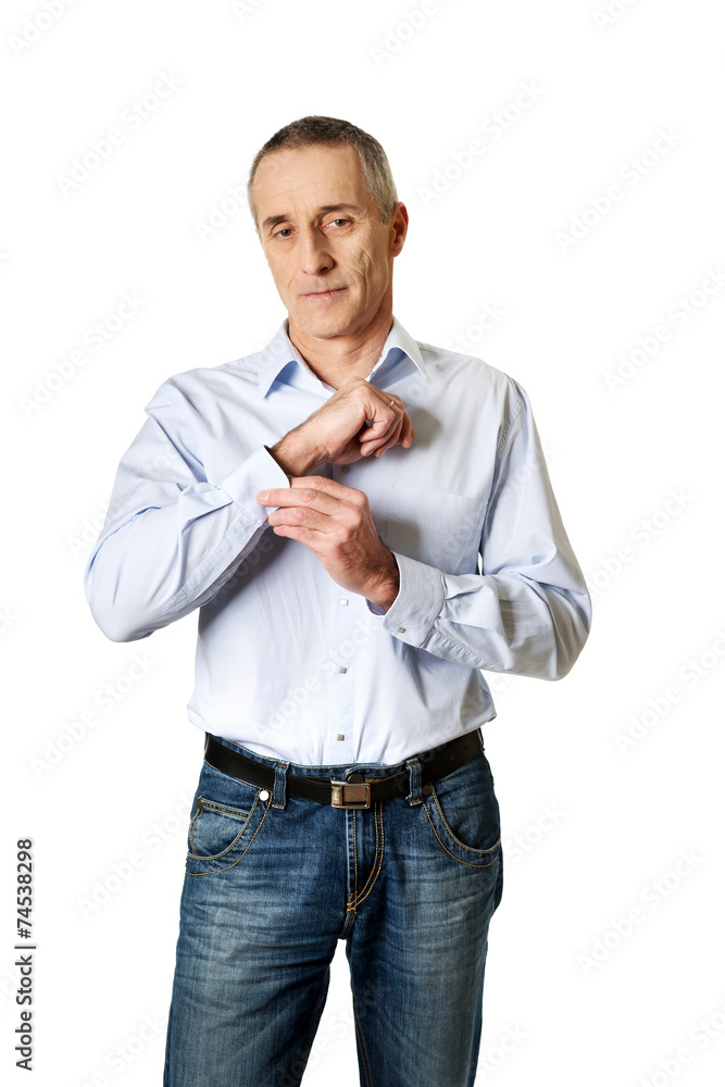 Handsome man buttoning his cuff Handsome man buttoning his cuff