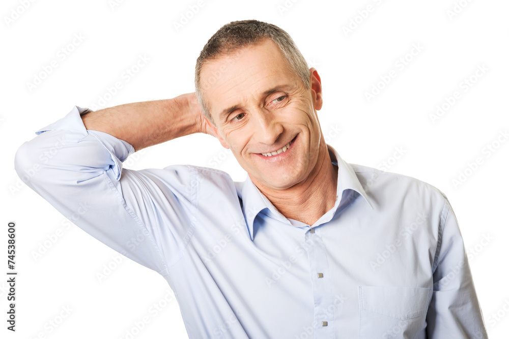 Portrait of a good looking man touching his head Portrait of a good looking man touching his head