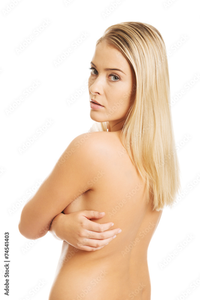 Fototapeta premium Portrait of nude woman looking through her shoulder