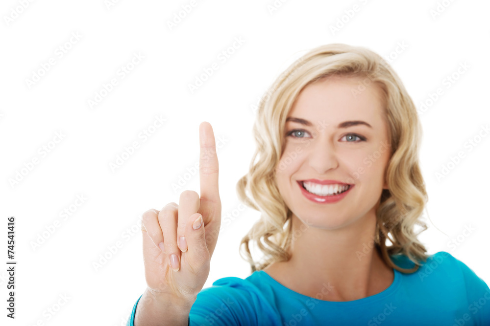 Portrait of woman pushing imaginary button Portrait of woman pushing imaginary button