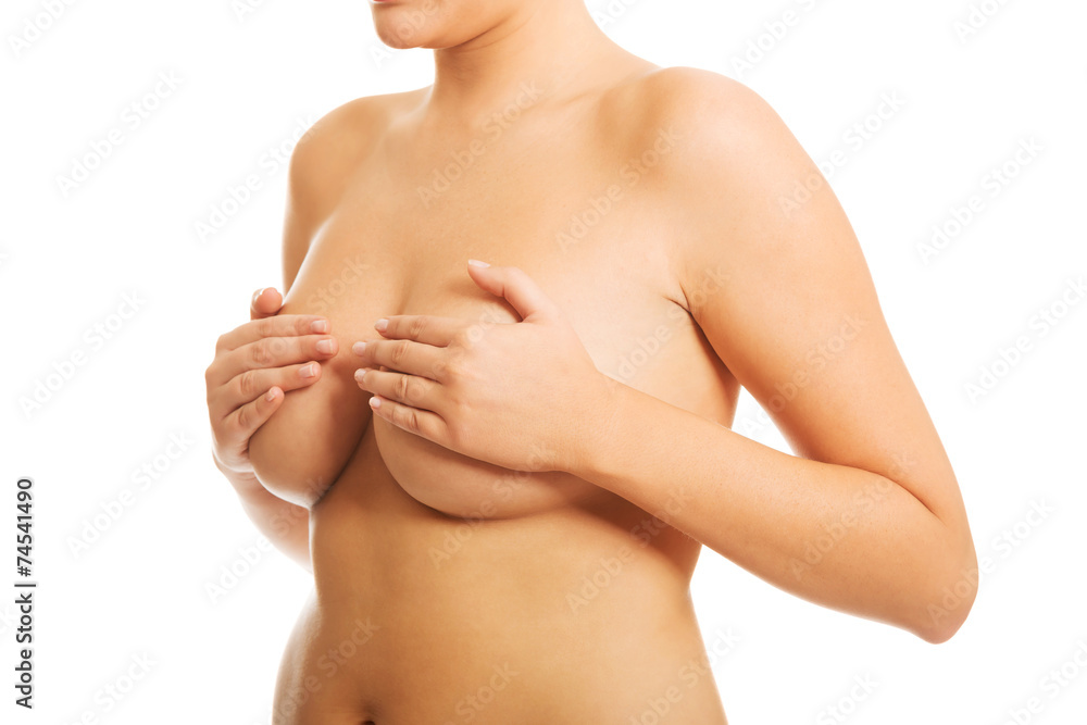 Fototapeta premium Nude woman examining her breast