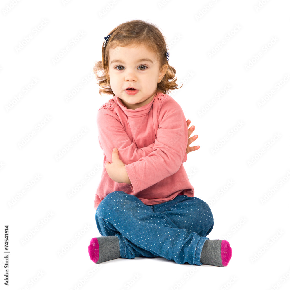 Little girl sitting over isolated white background Little girl sitting over isolated white background
