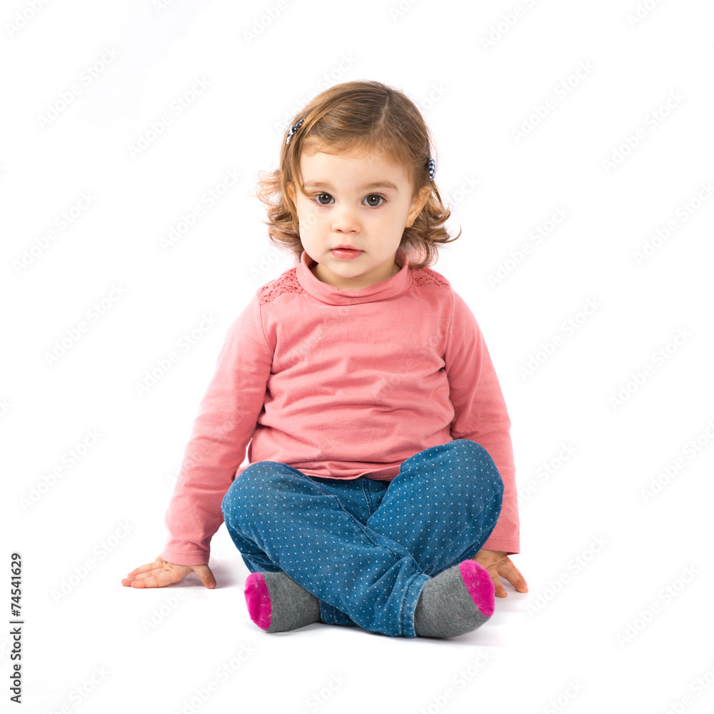Cute girl sitting over white background Cute girl sitting over white background