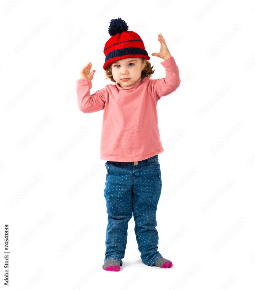 Little girl putting on a Christmas hat over white background Little girl putting on a Christmas hat over white background