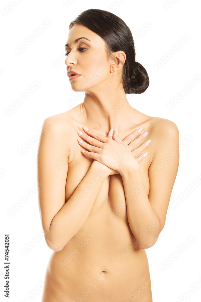 Front view of nude woman crossing her arms on chest Stock Photo