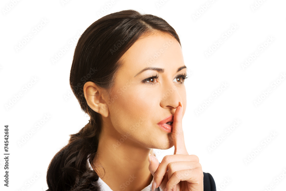 Portrait of businesswoman making silent sign