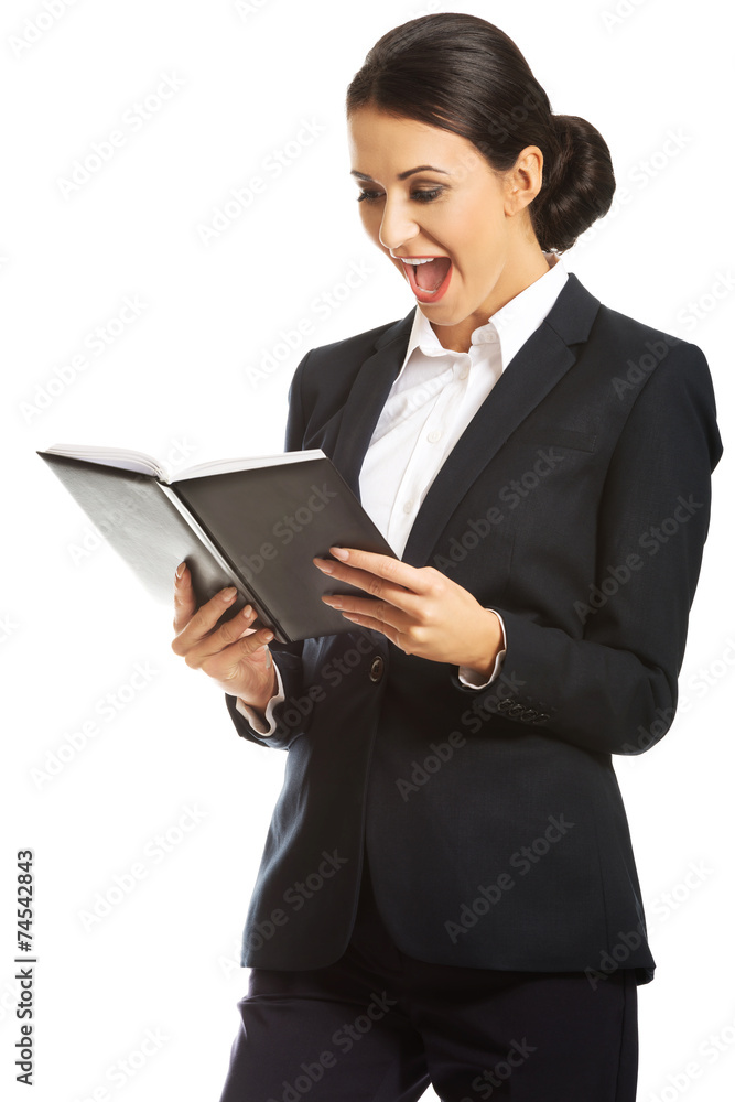 Surprised businesswoman reading her notes Surprised businesswoman reading her notes