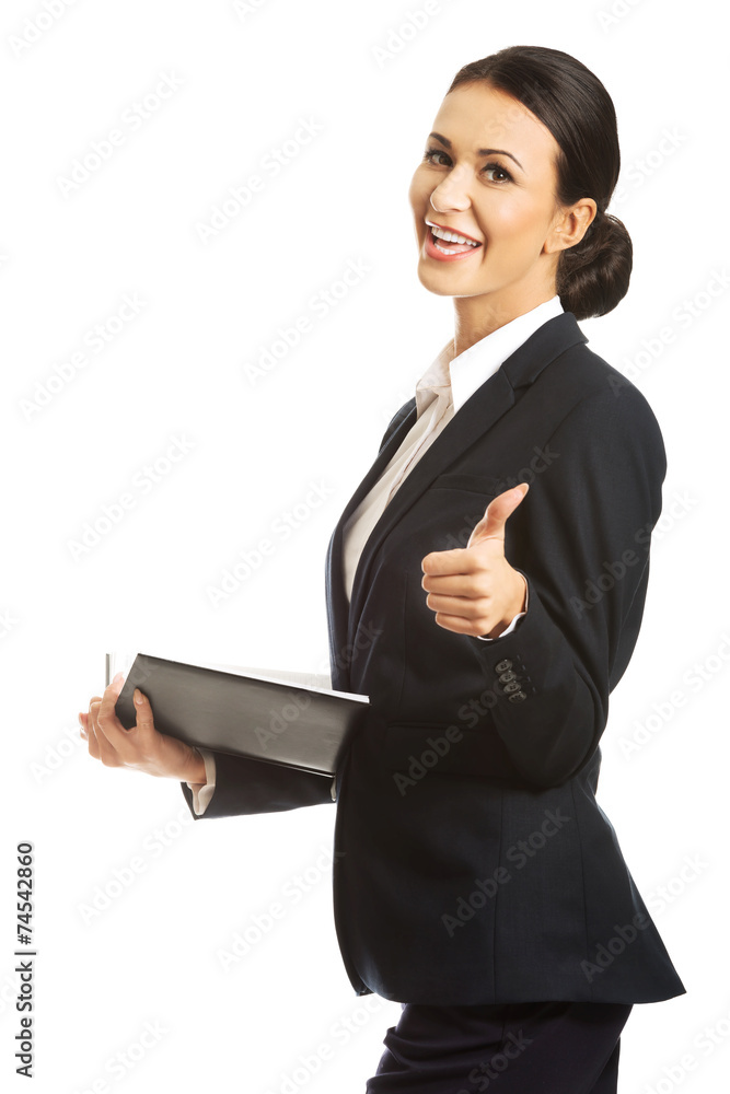 Businesswoman holding notes and showing thumb up Businesswoman holding notes and showing thumb up