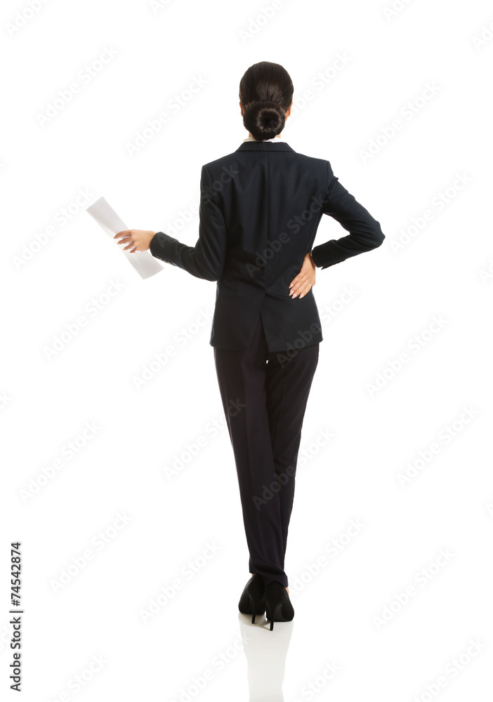 Back view of a businesswoman with paper notes Back view of a businesswoman with paper notes