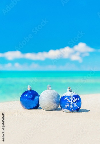 Christmas tree decorations on sea sandy beach