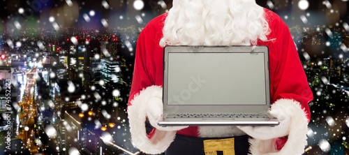 close up of santa claus with laptop