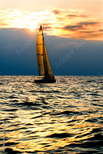 Sports yacht in the sea at sunset.