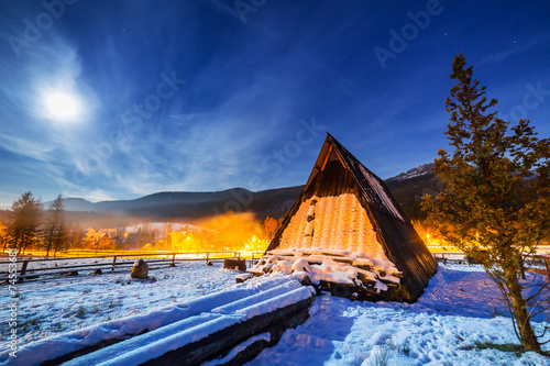 Wooden shelter in Tatra mountains at night, Poland photo