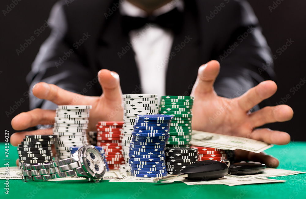 poker player with chips and money at casino table poker player with chips and money at casino table
