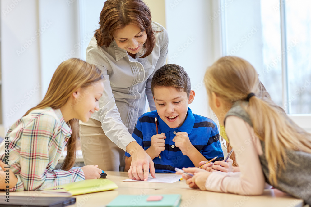 group of school kids writing test in classroom