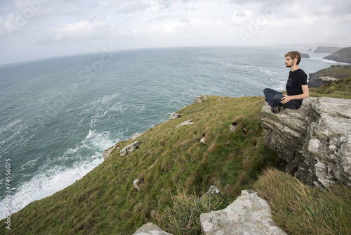 Sitting on the edge of Grass Hill cliff