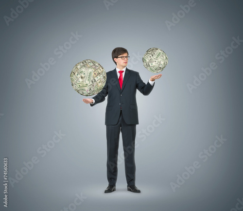 businessman holding dollar sphere photo