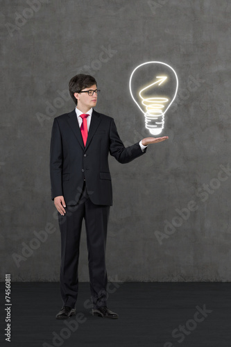 businessman holding drawing lightbulb