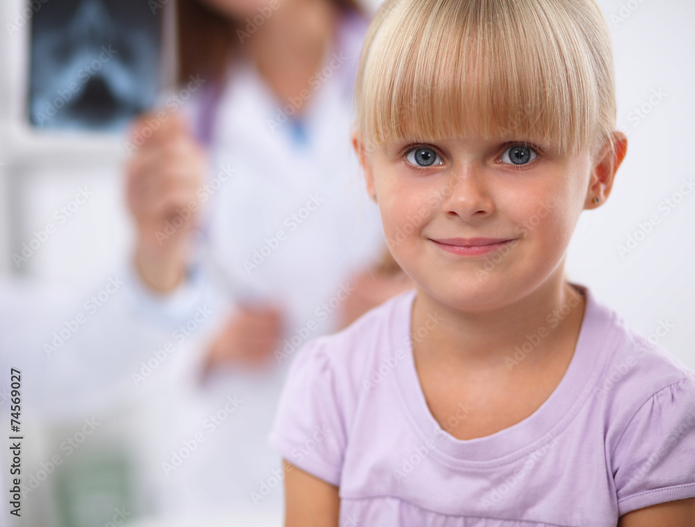 Female doctor examining child with stethoscope at surgery Female doctor examining child with stethoscope at surgery