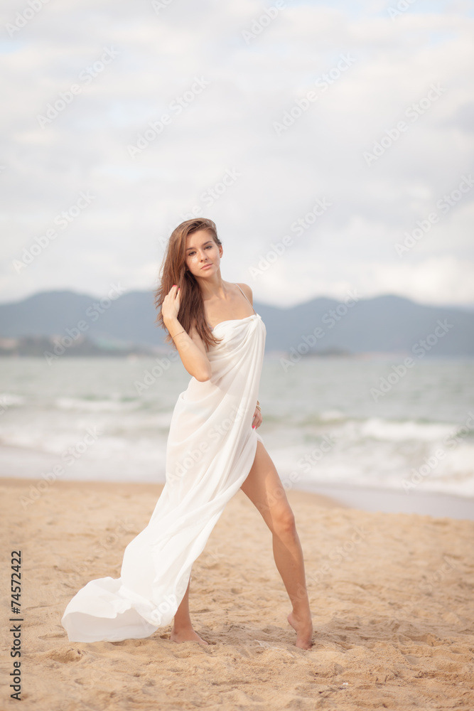 Beautiful Girl With White Scarf on The Beach. Travel and Vacation. Freedom Concept Beautiful Girl With White Scarf on The Beach. Travel and Vacation. Freedom Concept