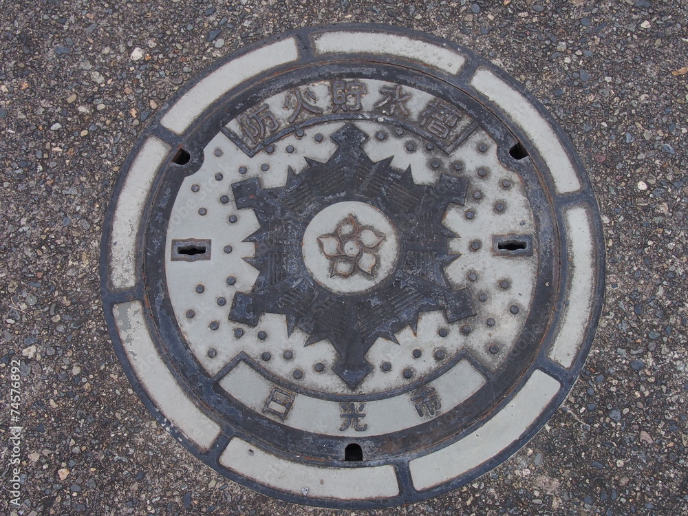 Manhole drain cover on the street at Nikko, Japan