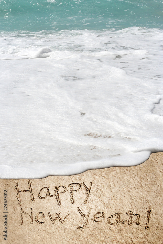 Conceptual Happy New Year text in sand and water Conceptual Happy New Year text in sand and water